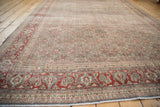 Distressed vintage Tabriz carpet corner, showcasing the cherry red Samovar Turtle border.