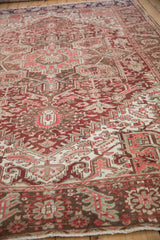 Vintage Distressed Heriz carpet showing worn pile, geometric motifs in red, bronze, and beige.