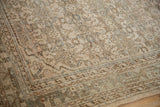 Distressed vintage Hamadan rug border, showing even wear and time-softened beige and blue tones.