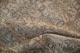 Softened pile of a distressed Persian Hamadan carpet with intricate Herati design in beige and blue.