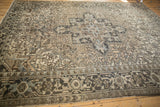 Visible wear and abrashes on a Vintage Distressed Heriz rug, with medallion and floral field.