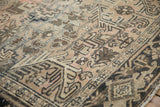 Distressed vintage Heriz carpet detail, highlighting geometric patterns, abrashes, and muted tones.
