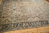 Distressed Heriz carpet border with turtle motif, charcoal and pale coffee field abrashes.