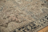 Distressed vintage Heriz rug showcasing turtle samovar border and geometric field with abrashes.