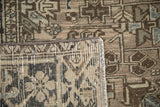 Distressed Vintage Heriz carpet: textured geometric pile and visible hand-knotted foundation.