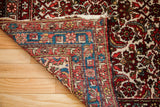 Vintage Hamadan rug with time-softened red Herati front and vibrant geometric reverse.