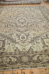 Distressed Mehrivan rug corner showing geometric patterns, muted beige and brown tones, and fringe.