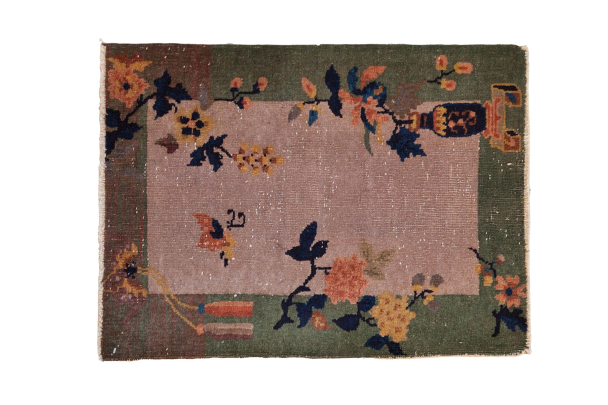 Dusty mauve antique Art Deco mat featuring pictorial vased plant and celadon green border.