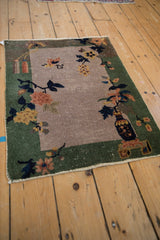 Art Deco rug's lower left corner, dusty gold and terracotta blossomed branches.
