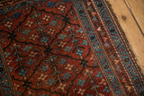 Vintage Mehriban rug detail: burgundy tree of life pattern, sapphire geometric border, and visible wear.