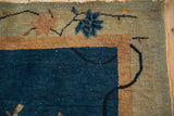 Corner detail of Chinese Art Deco rug: cobalt blue field, golden border, pale green with blush lotus.