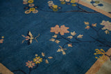 Antique Chinese Art Deco rug detail: pale florals and a butterfly on a cobalt blue field.