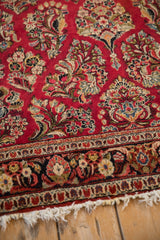 Intricate floral border and soft, bloomed ivory fringe on a vintage German Sarouk rug corner.