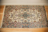 Ivory vintage Kerman rug, blue and rose European-style floral pattern.