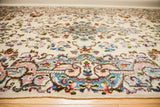 Ivory Kerman rug with intricate blue and pink European floral motifs.