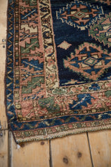 Geometric border and intact dark cord selvage of the antique Caucasian rug corner.