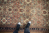 A view from above showing the detailed pattern and wear to the knot heads of an antique Malayer rug.