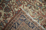 Corner detail of an antique Malayer showing its hand-knotted foundation and cotton fringe.