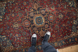 Detail of the Serapi-inspired stepped medallion and intricate blossoms on an antique Malayer rug.