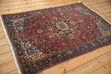 Diagonal view of an antique Malayer rug, emphasizing the Serapi-style medallion and intricate floral field.