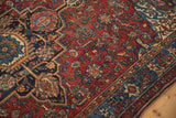 Fine knotting and stepped contour on a ruby red and sapphire blue antique Persian Malayer rug.