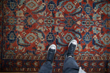 Overhead detail of an antique Malayer rug's large Herati design in ruby red and sapphire blue.