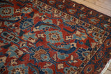 Even wear across the hand-knotted pile of an antique Malayer rug with a bold Herati design in red and blue.
