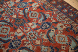 Visible knot heads and even wear on the pile of an antique Persian Malayer rug with red and blue motifs.