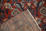 A folded corner reveals the intricate hand-knotted foundation of an antique Persian Malayer rug.