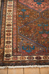 Pomegranate border and tree of life motifs on a vintage Kurdish Hamadan rug.