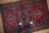 A view looking down on the staggered quatrefoil medallions of a vintage Persian Karaja rug.