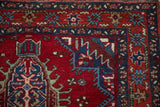 Meandering vine and geometric palmette motif on the sapphire blue border of a fine Karaja rug.