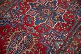 Finely woven hook and latch medallions in sapphire blue and cherry red on a vintage Persian Karaja rug.