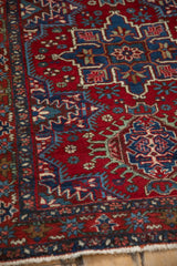 Detailed texture of the low pile and geometric hook designs on a vintage Persian Karaja rug.