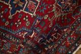 Close view of a vintage Karaja rug's even pile and visible knot heads in cherry red and sapphire blue.