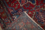 Folded corner of a fine Karaja rug, showing the hand-knotted back and cherry red pile.