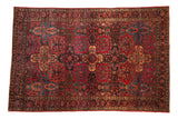 Antique Sarouk rug, allover panel design with inverted coloration, red and navy floral motifs.