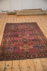 Antique Sarouk rug detail: raspberry red, navy blue, dusty gold floral panel design.