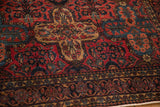 Intricate Persian Sarouk rug borders, featuring raspberry red and navy floral motifs.