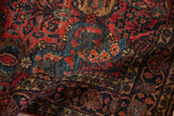 Hand-knotted Sarouk pile, raspberry red, dark navy blue floral motifs, dusty gold highlights.