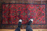 A vintage Lilihan rug seen from above, showing its scale and detailed floral pattern.