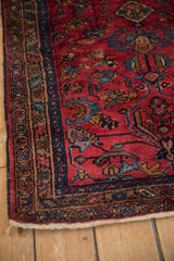 Corner of a vintage Lilihan rug highlighting the even pile and detailed floral side border.
