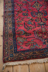 Corner view of a vintage Persian Lilihan rug showing the floral border, secure selvage, and fringe.