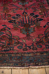 Vintage Lilihan rug's unique meandering vine border motif in blue and red with fringe.