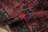 Vintage Lilihan rug's high sheen magenta pile with intricate floral bouquets and unique vine border.