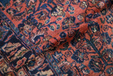 Varied high and low wool pile on a vintage Persian Lilihan rug in dusty rose and navy.