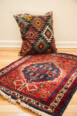 Northwest Persian geometric medallion rug featuring a bold red field and deep blue.