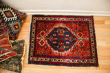 Fringed bottom corner of the vintage Northwest Persian rug, with red field and border patina.