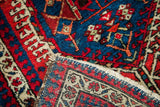 Fine, even hand-knotted foundation contrasted with bold red and blue geometric pile.