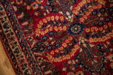 Varied pile texture of a vintage Sarouk rug with dense sapphire blue and sand floral details.
